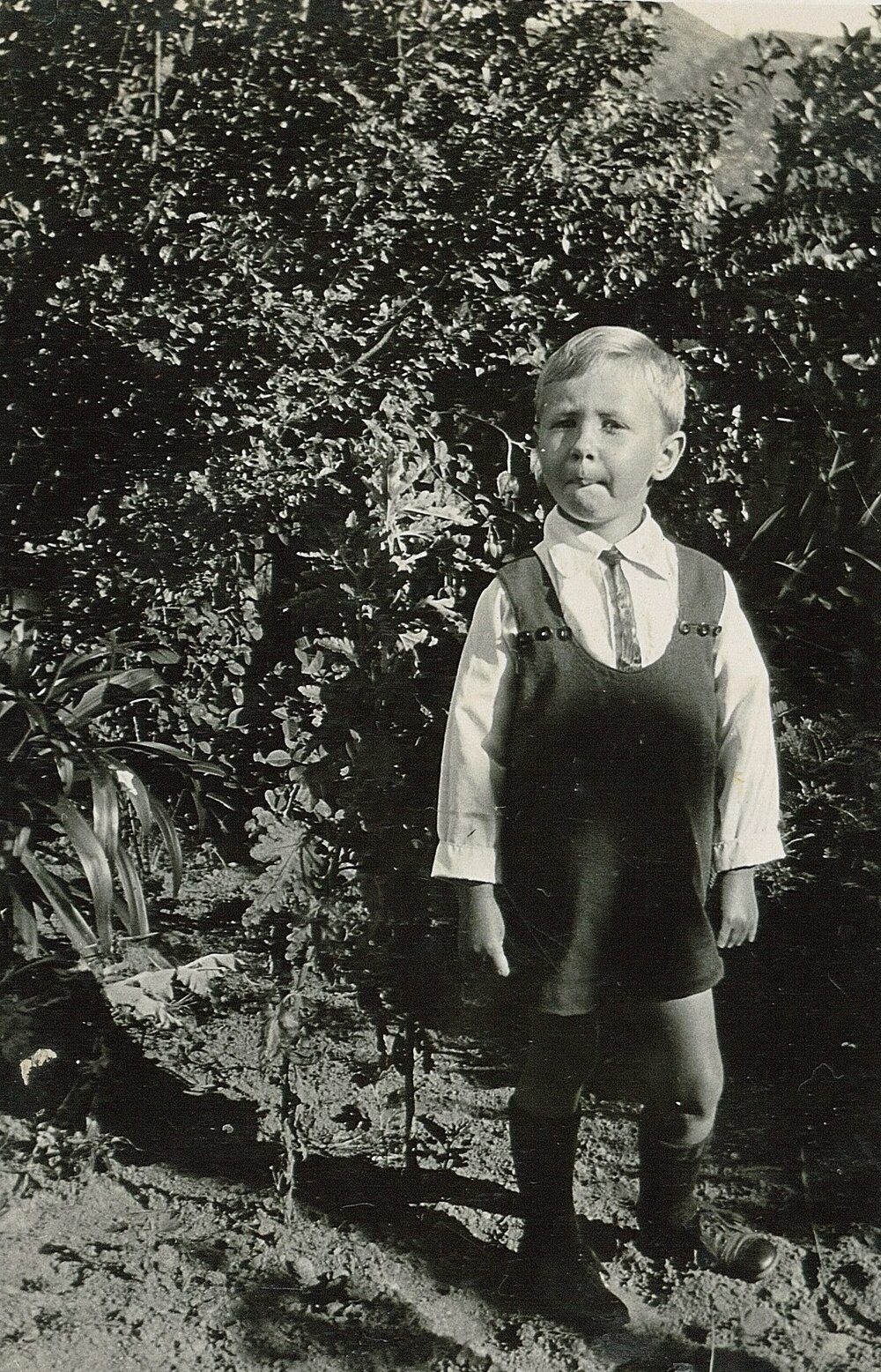 Little Ian in tie and romper suit 