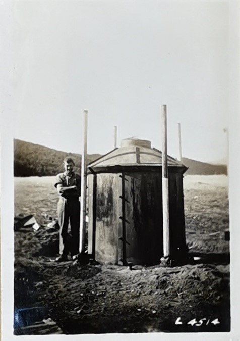 Man standing next to a Charcoal kiln