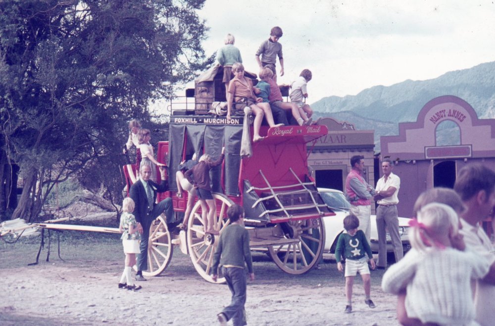 Children playing on Newman's mail coach