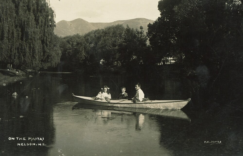 Three people in a boat on the Maitai River
