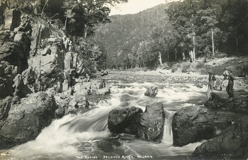 Person with gun at the rapids of Te Hoiere / Pelorus River