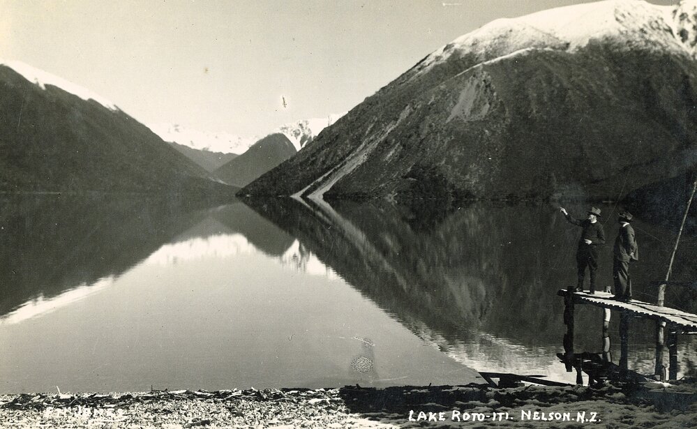 Two people on the jetty at Lake Rotoiti 