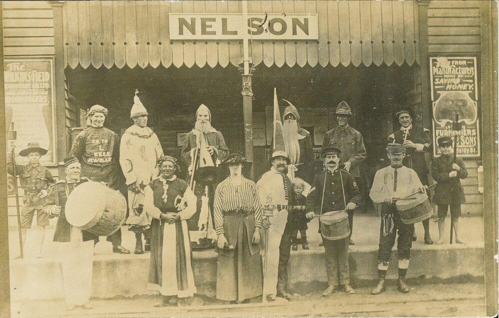 Railway workers in fancy dress outside Nelson Station
