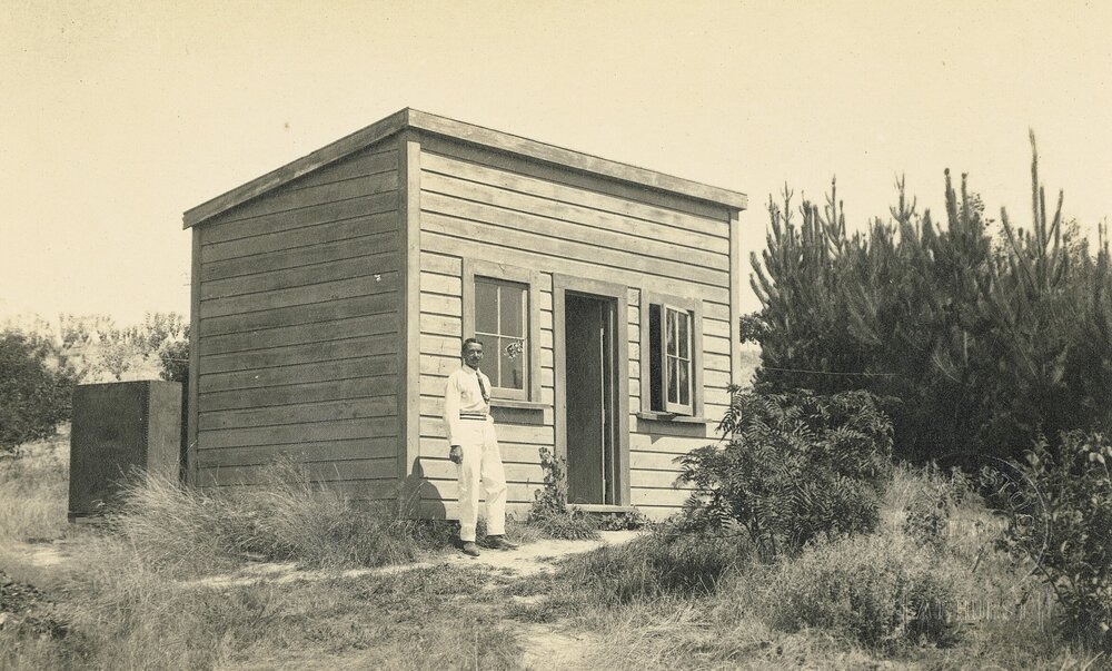 Man in front of cottage in Tasman
