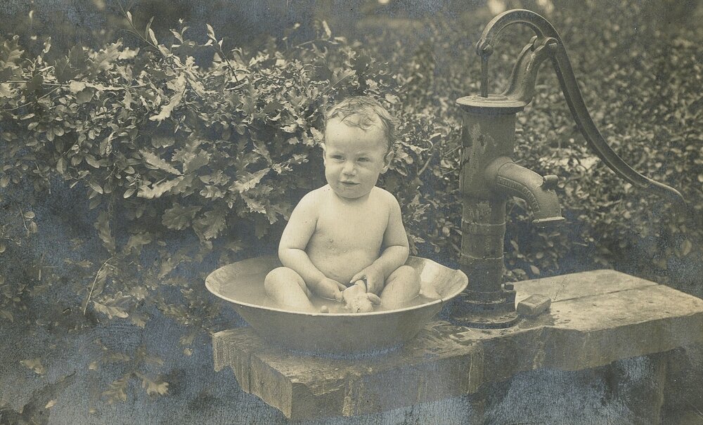 Baby taking a bath outside