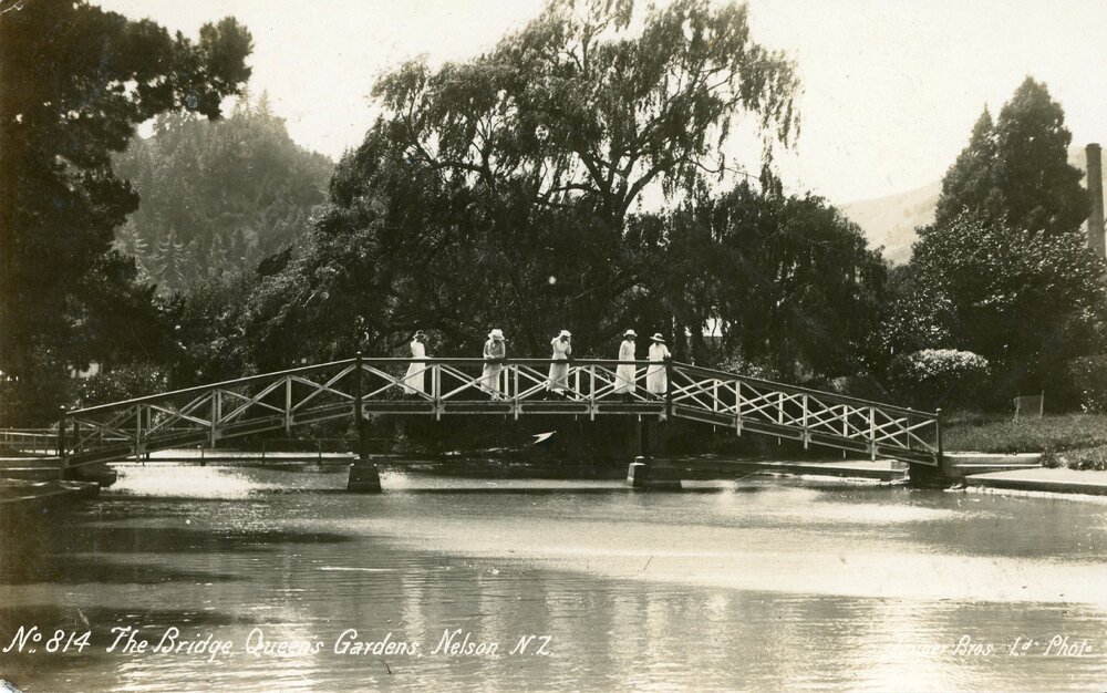 Women in white on bridge in the Queen's Gardens