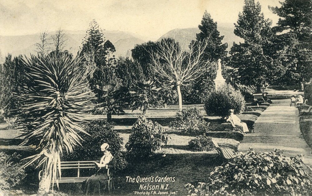 People seated on benches in the Queen's Gardens