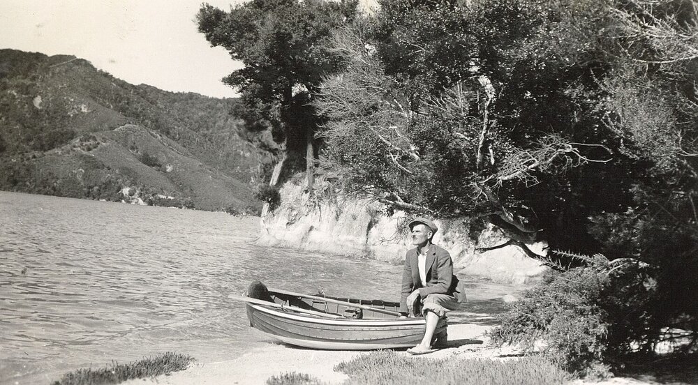 Man with a dingy beside the water