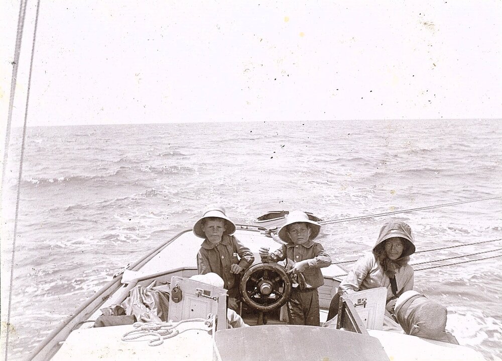 Children steering a yacht