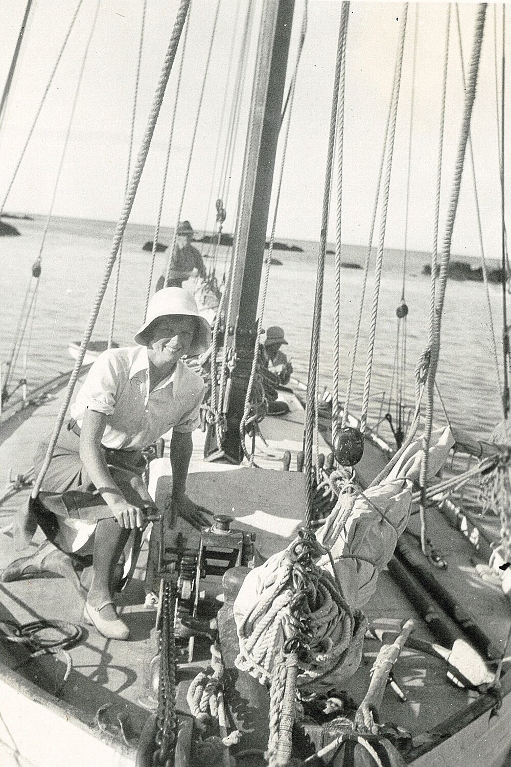 Woman kneeling on deck of a yacht