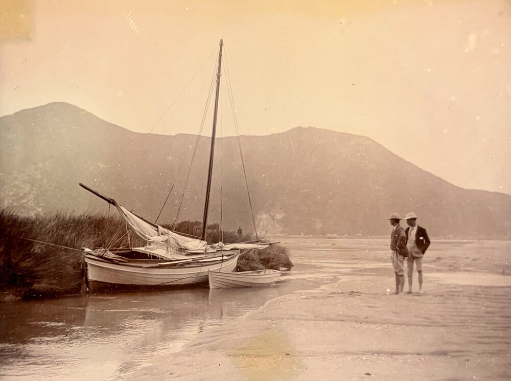 Men and small yacht at the shore