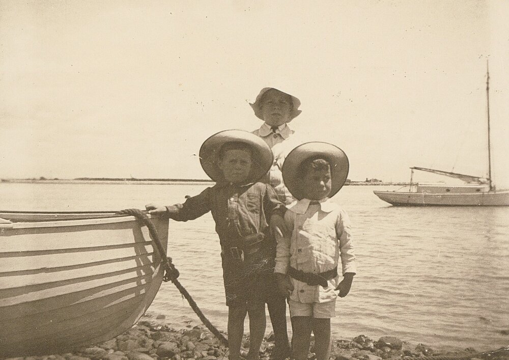 Children in front of boat