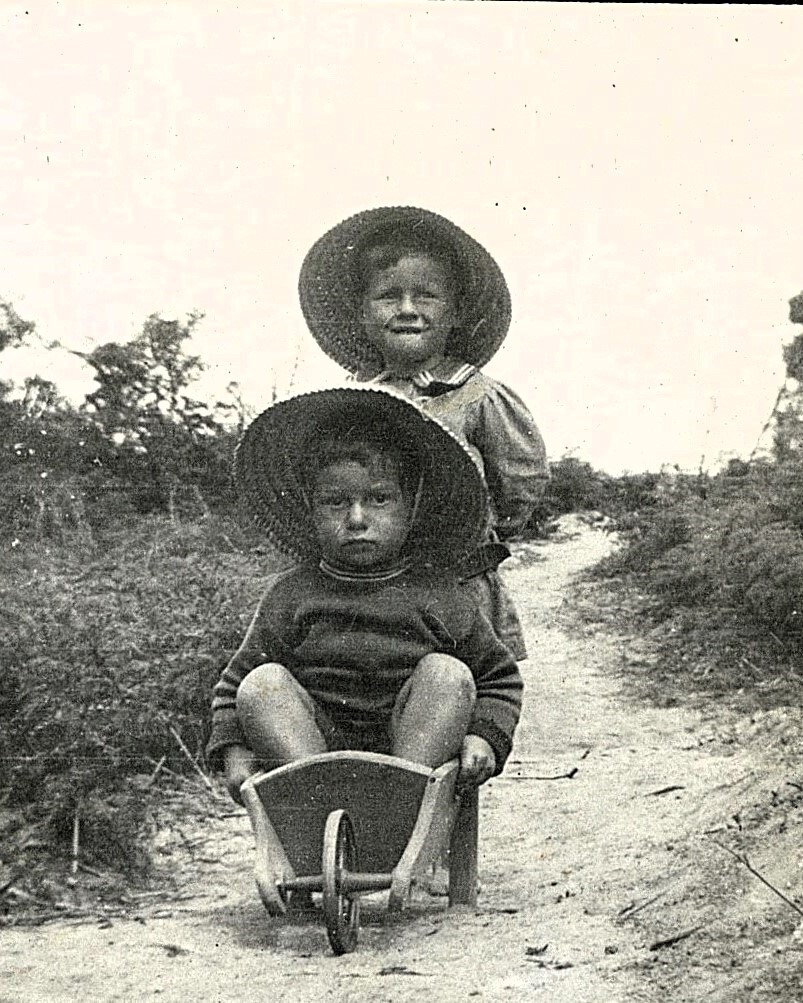 Children with toy wheelbarrow