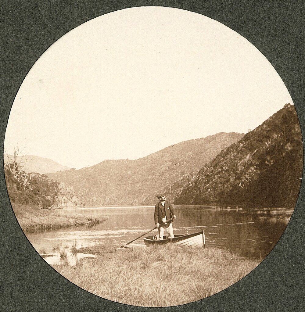 Man standing up in a rowboat