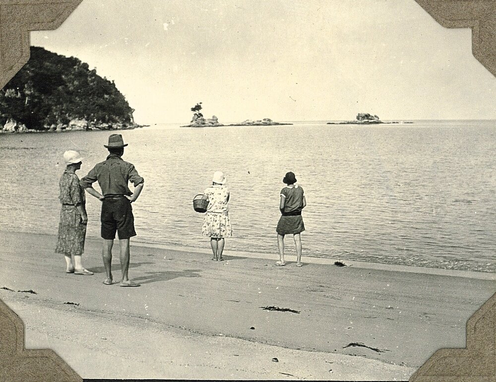 Four people on a beach in the Abel Tasman