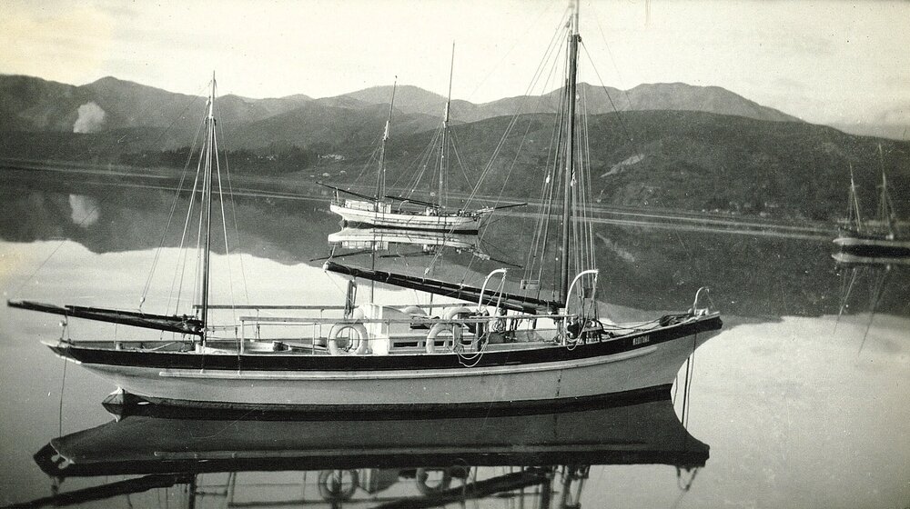 Two boats mirrored in the water