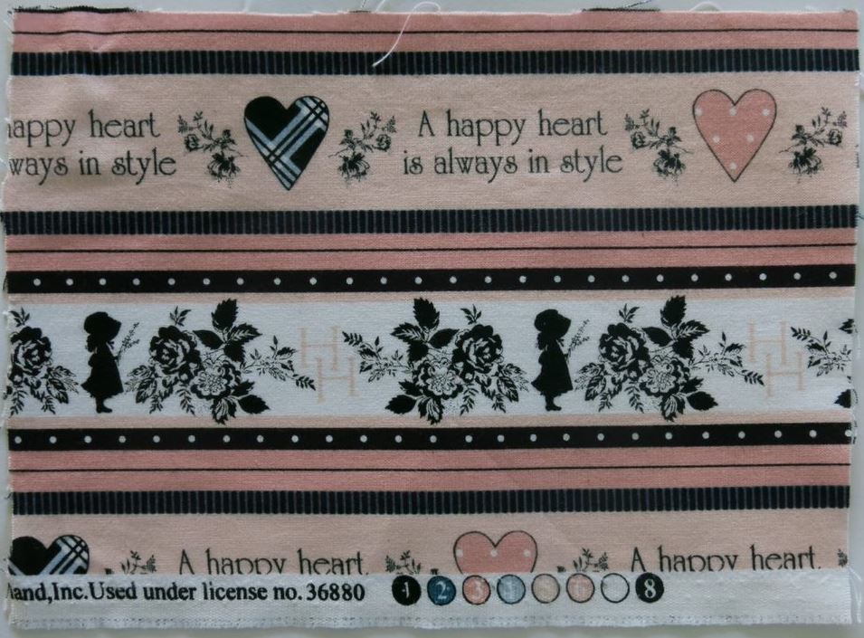 Fabric quilt square with children, hearts and flowers and the words A happy heart is always in style