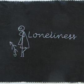 Black fabric quilt square embroidered with the word loneliness and a person