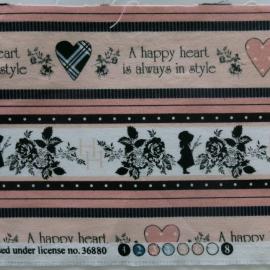Fabric quilt square with children, hearts and flowers and the words A happy heart is always in style