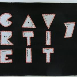Black quilt square appliqued with the word creativity