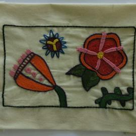 Quilt piece with emboidered flowers, sun and cactus