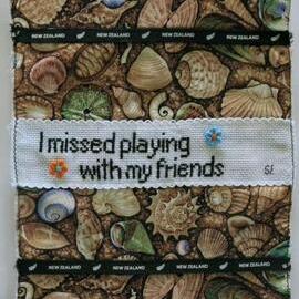 Shell fabric quilt piece with cross stitch flowers and words I missed playing with my friends