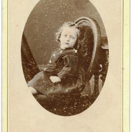 Small child sitting on a chair 