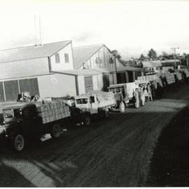 Apple trucks lined up with apples for shipping