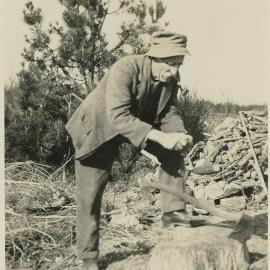 Mr T. L. Austin chopping wood