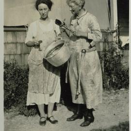 Two women with preserving pan and spoons