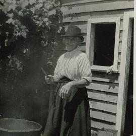 Mrs Robertson outside with large pot