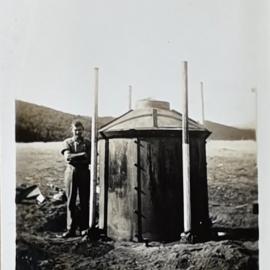 Man standing next to a Charcoal kiln