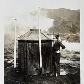 Man looking at smoke coming out of a Charcoal kiln