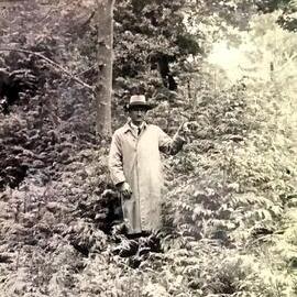 Man indicating tree growth