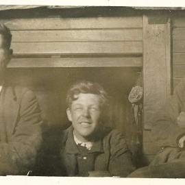 Three men in front of fire surround