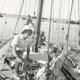 Woman kneeling on deck of a yacht