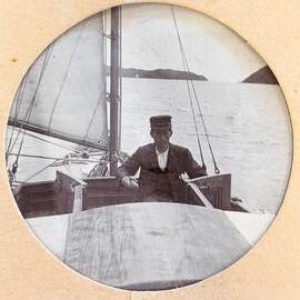 Man with glasses at the tiller