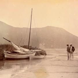 Men and small yacht at the shore