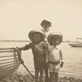 Children in front of boat