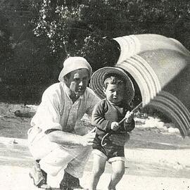Adult with child and parasol