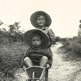 Children with toy wheelbarrow