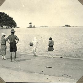 Four people on a beach in the Abel Tasman