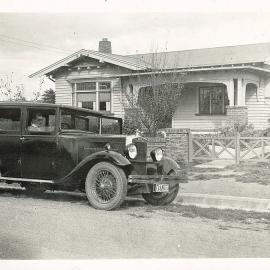 Motorcar in front of house