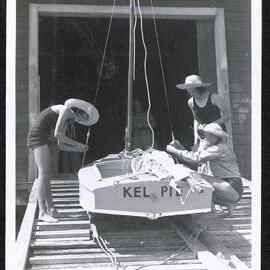 Three young women prepare Kelpie for launching